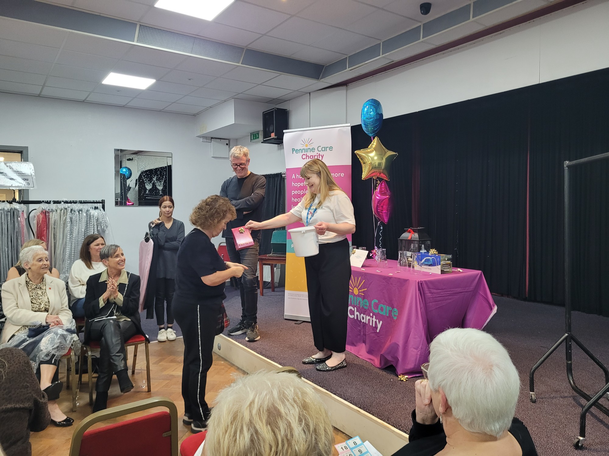 Handing out prizes at Pennine Care Charity fashion show.jpg
