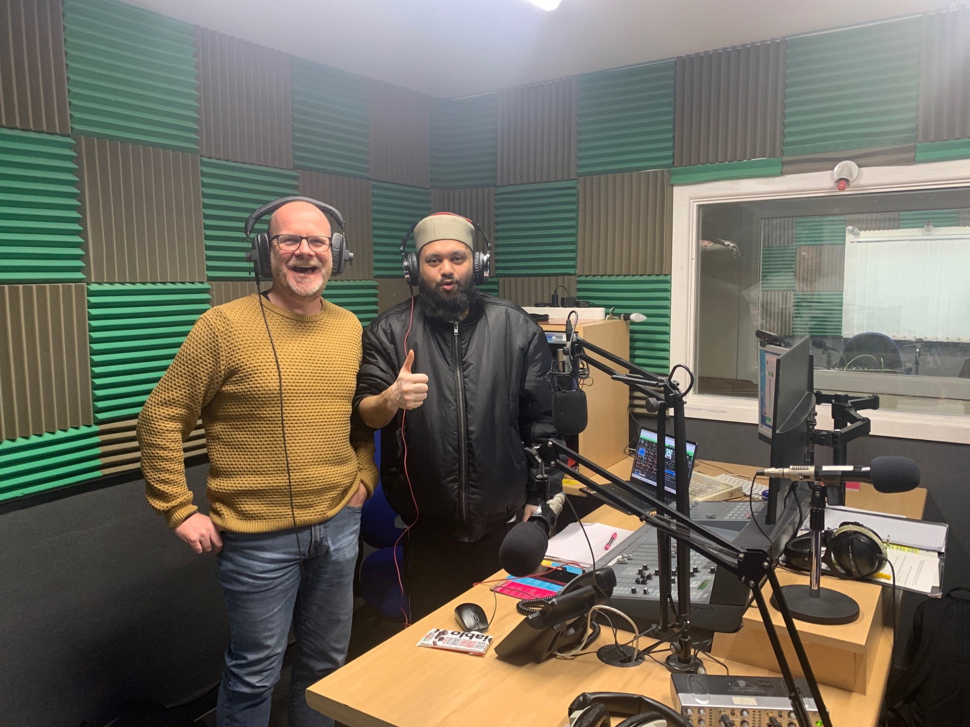 Pictured left is peer support worker David Hill stood next to patient Muhammad Khan in a radio newsroom.