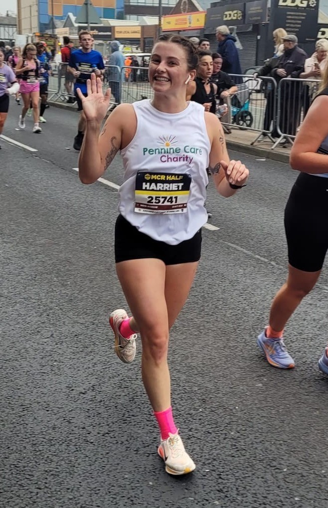 A runner wearing a Pennine Care Charity vest